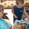 Boys helping grandma shell almonds