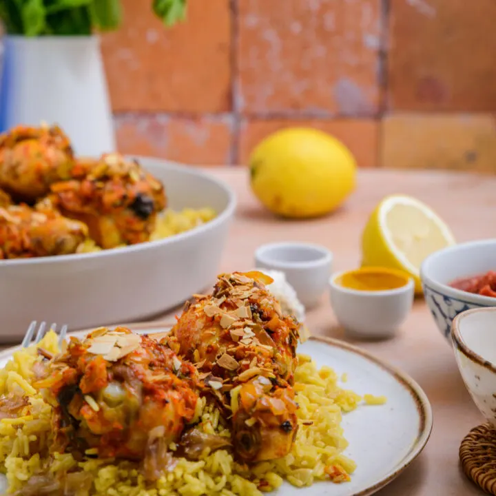 Baked chicken legs with harissa sauce and almonds.