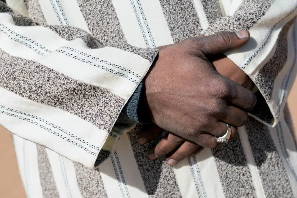 Moroccan man with his hands crossed in a traditional djallaba