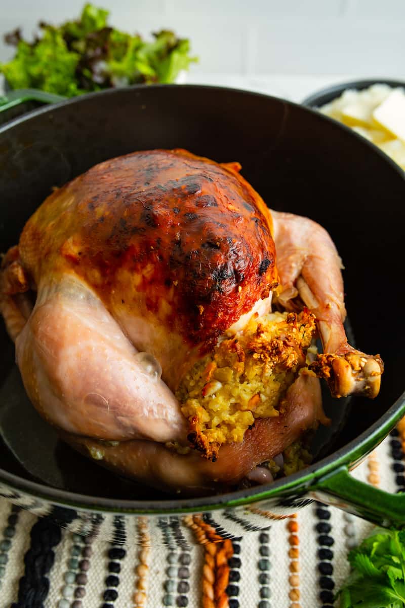 A whole roast chicken stuffed with a bread stuffing.