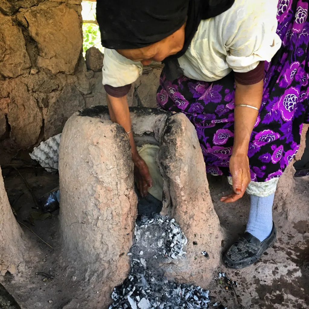 Putting tafernout bread into the oven