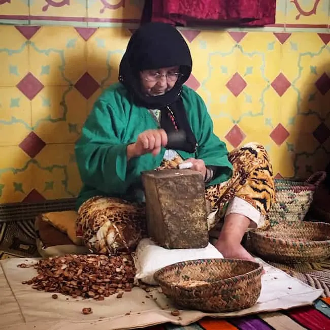 woman breaking argan nuts