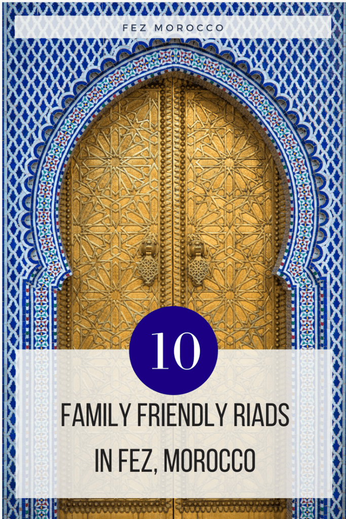 Golden arched door in Fez with a blue tile building