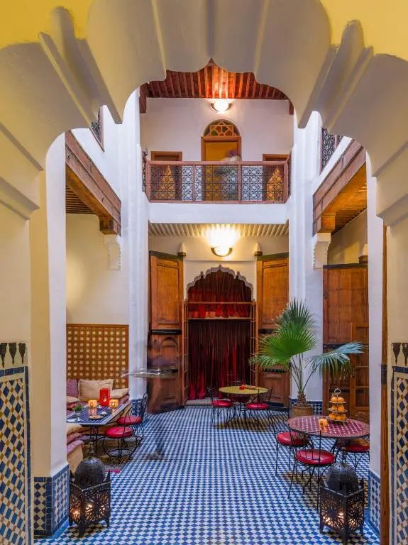 Courtyard of a Moroccan Riad in Fez, framed by an arched door