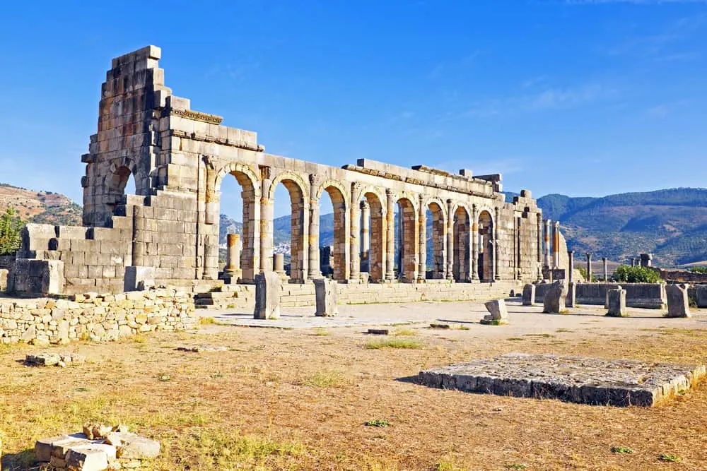 Ancient Roman ruins featuring pillars with a blue background. Fes day trip