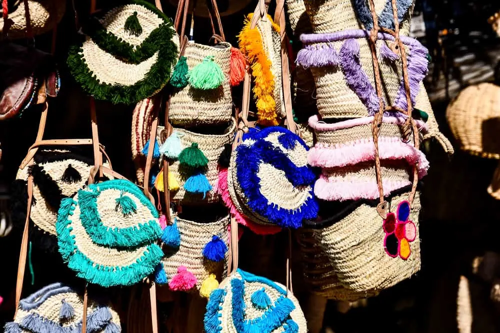 Multi-colored raffia purses hanging in a shop in Morocco