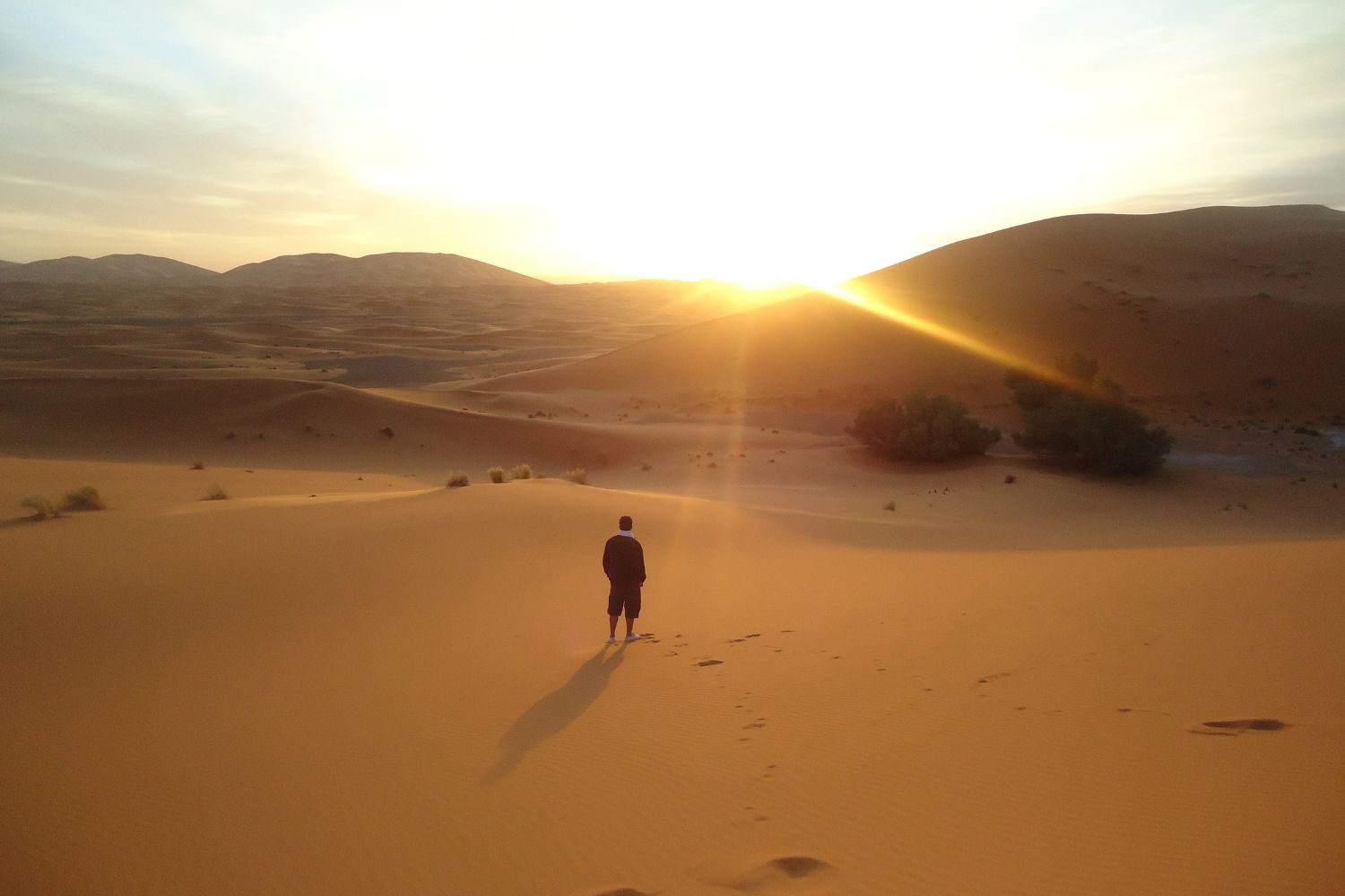 A man standing in the dessert during daylight