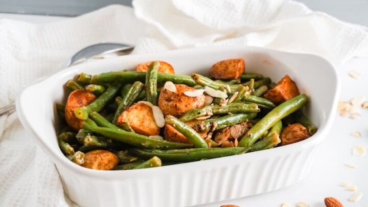 White serving dish with mixed paprika potatoes and green beans