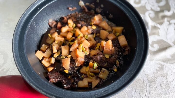 Bottom of a Black Tagine with cooked beef and quince inside