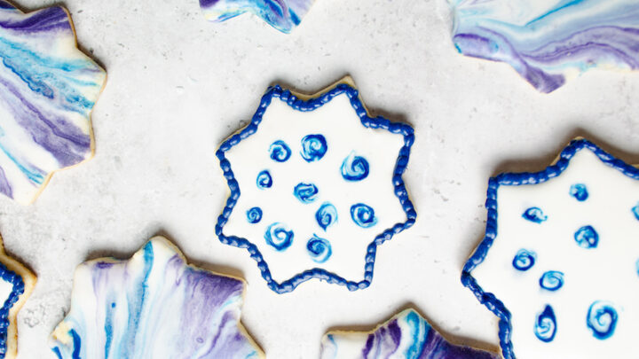 8 pointed star sugar cookies with purple and blue swirl glaze