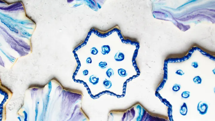 8 pointed star sugar cookies with purple and blue swirl glaze