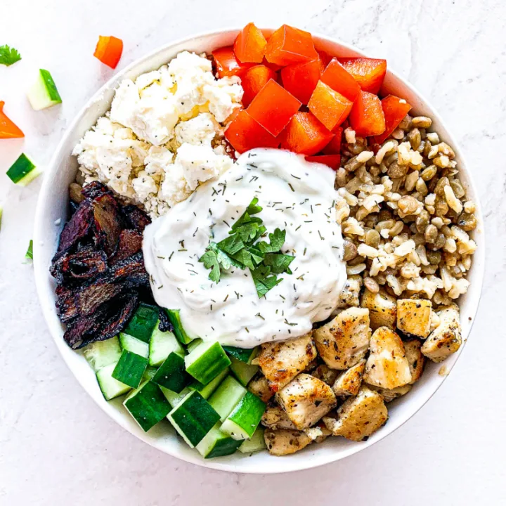 Vertical images of a bowl with rice Mediterranean vegetables