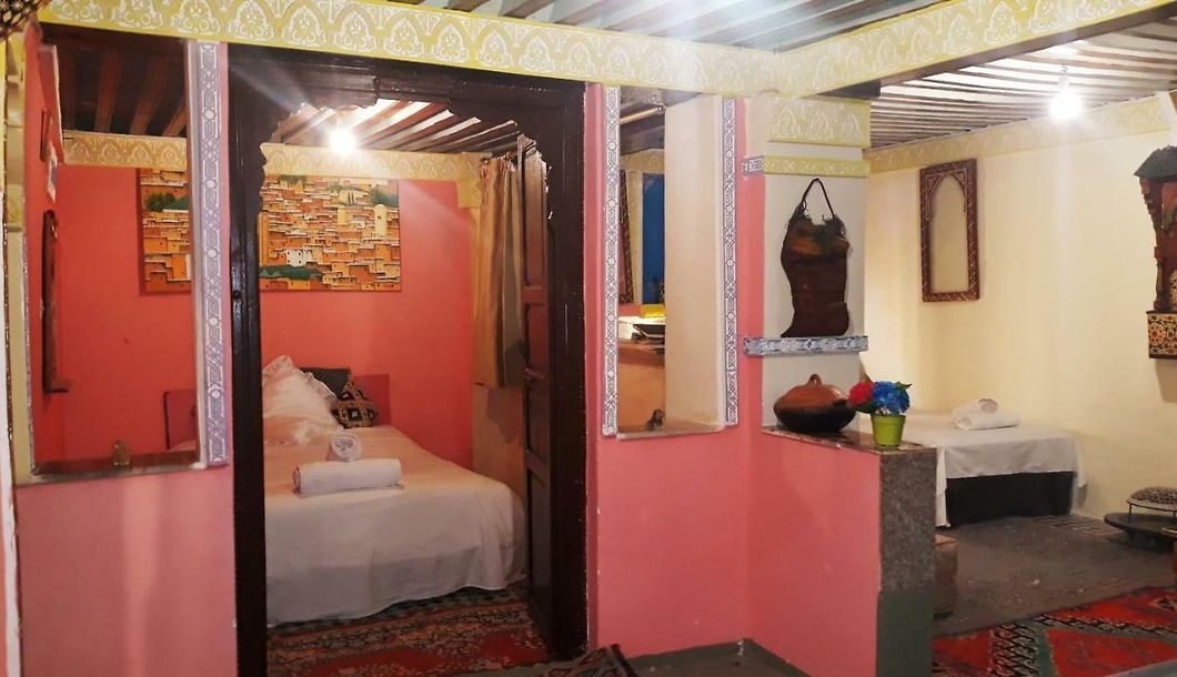 Small bedroom with wooden arch and a full size bed, Fez budget hotel
