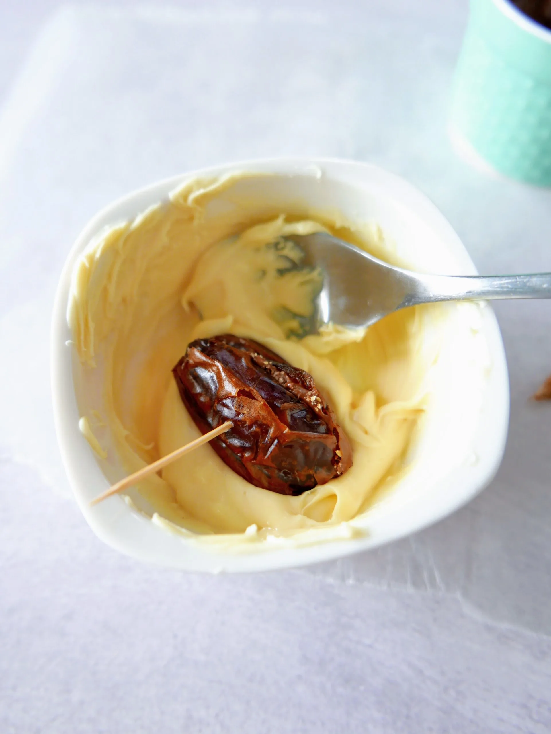 dates with toothpick on a melted chocolate