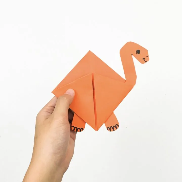 Hand holding a camel bookmark