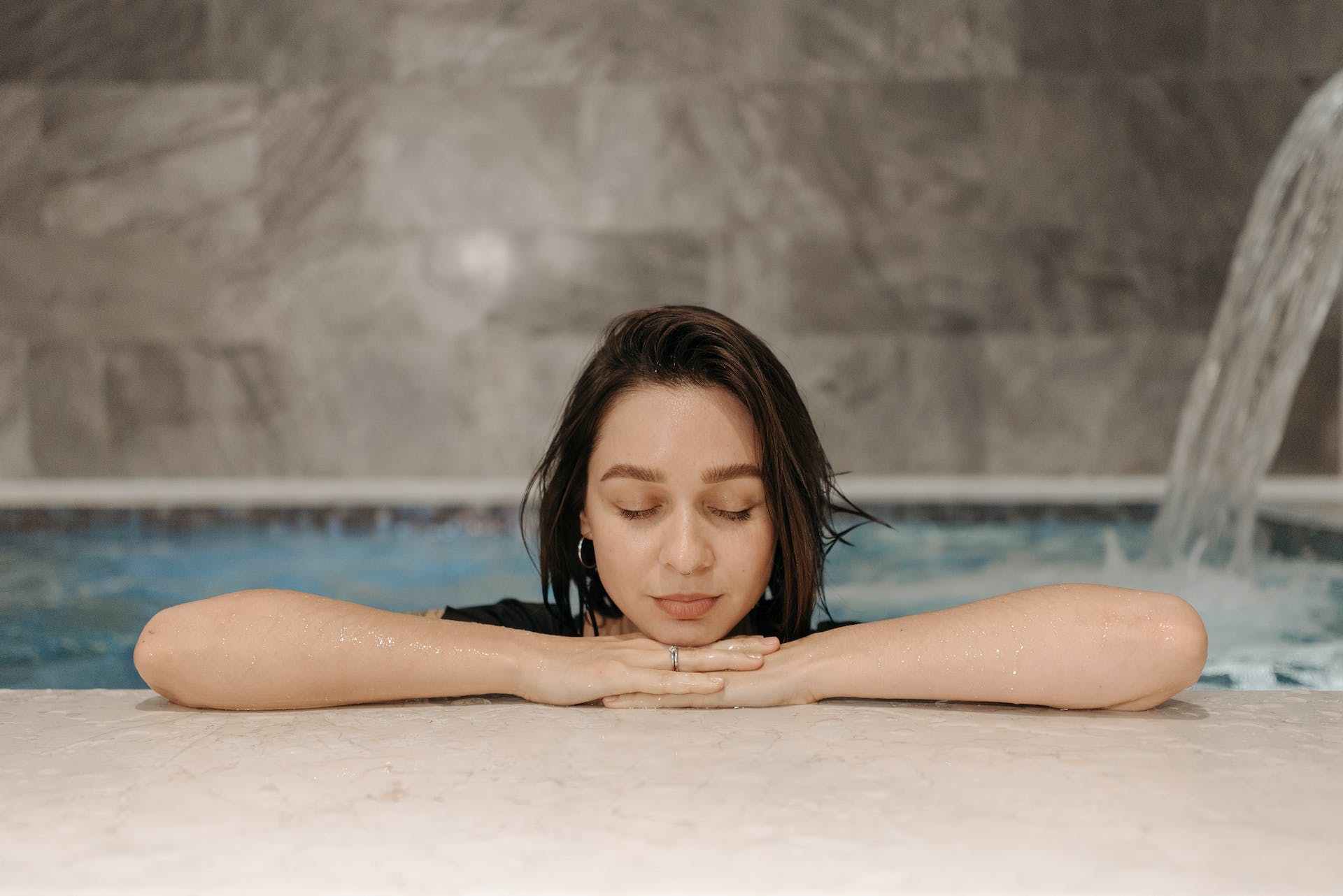 A Woman with Her Eyes Closed while in a Hammam