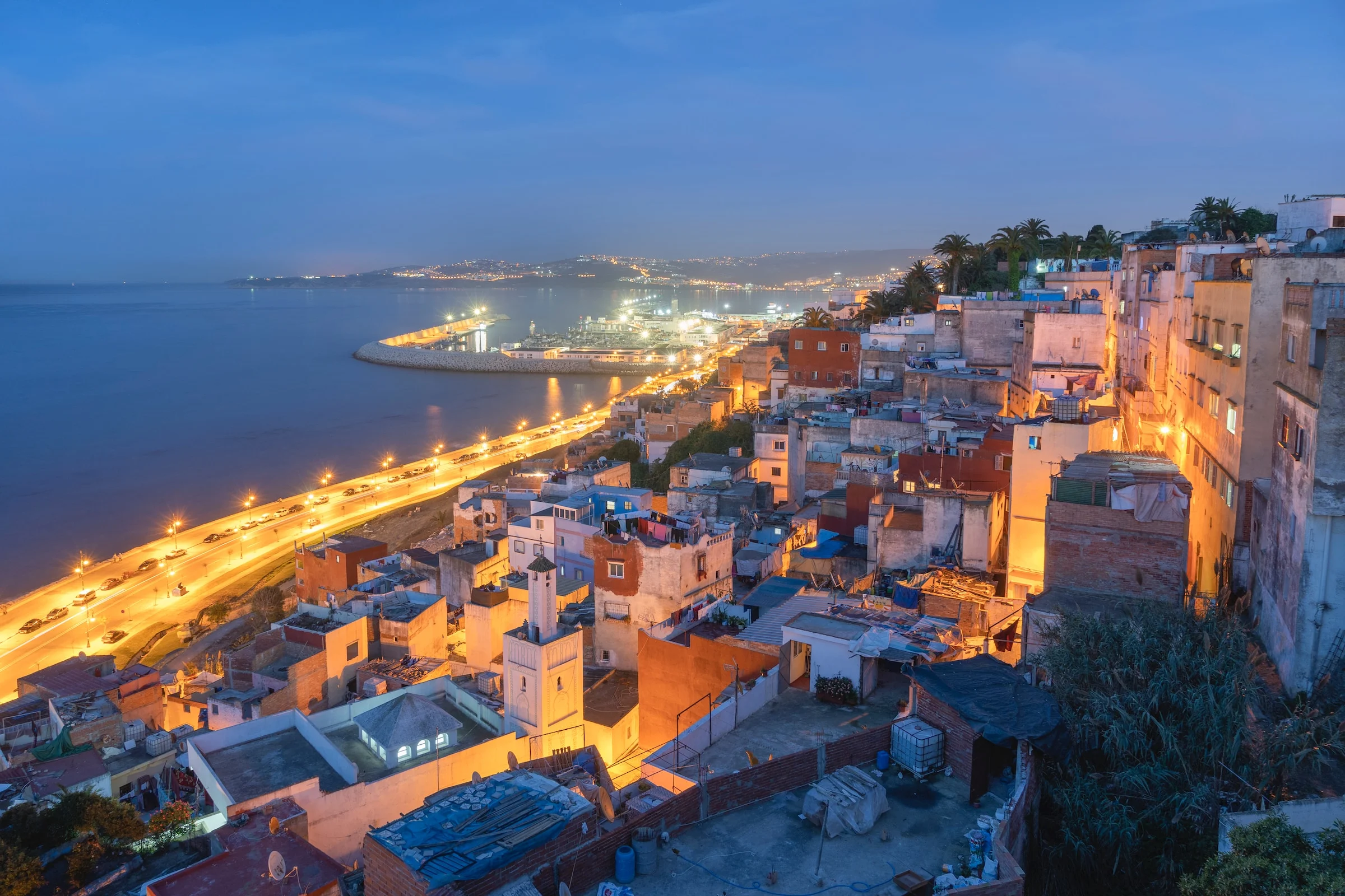 Aerial view of city near body of water during night time in Tangier, Morocco
