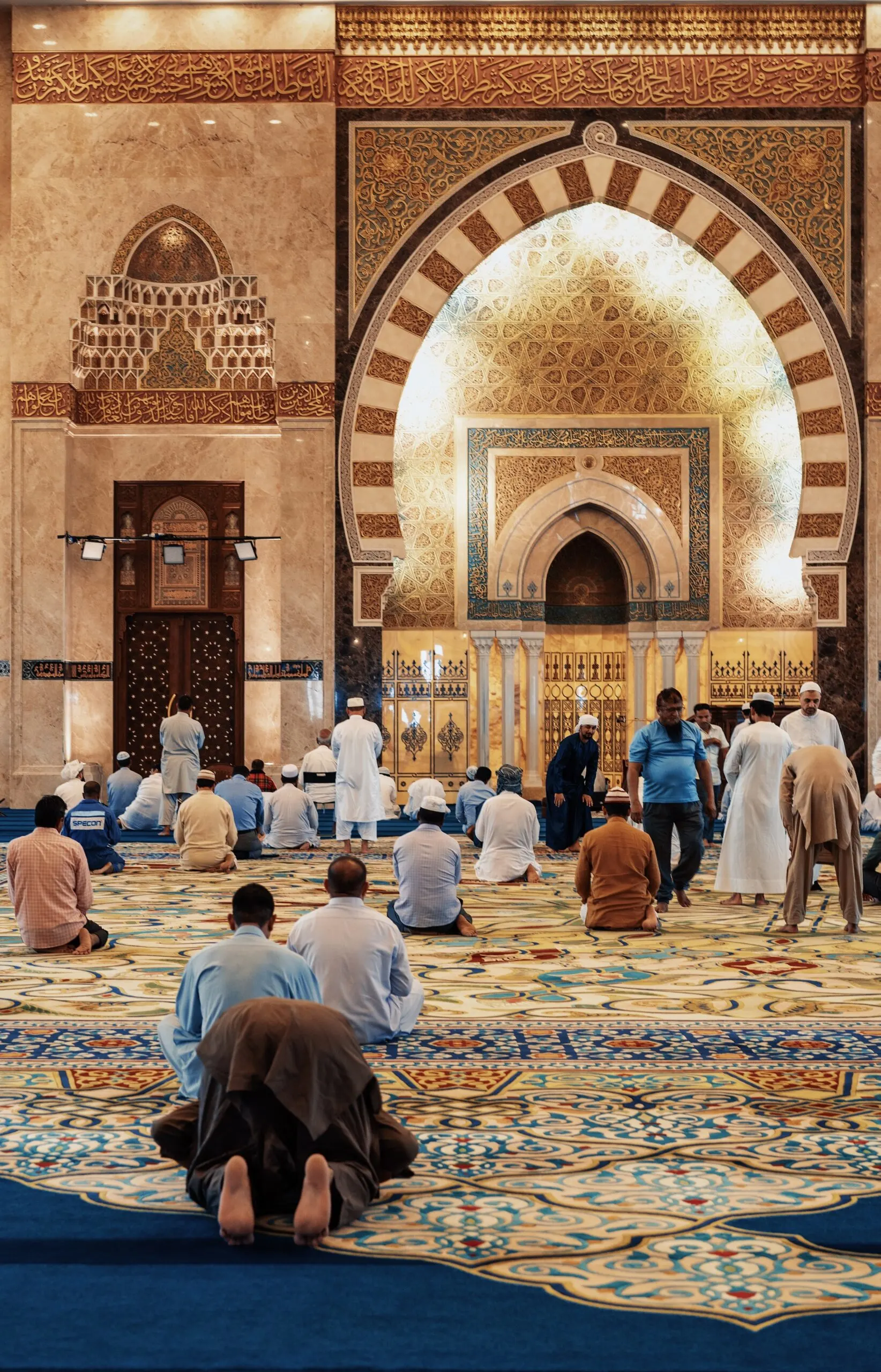 men kneeling and bowing inside a mosque