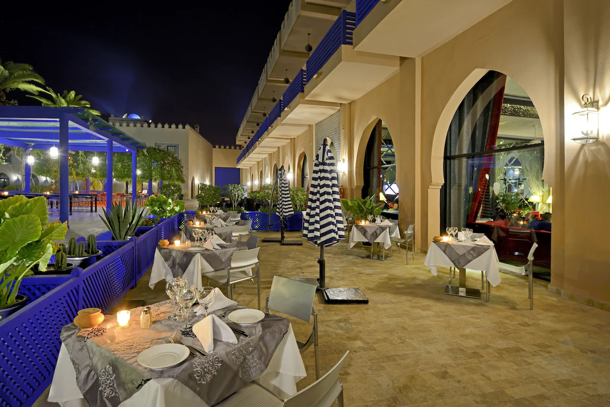 Restaurant in Adam Park Hotel and Spa Marrkech with outdoor dinner lit tables