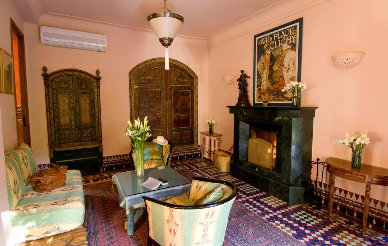 Inside one of the hotel rooms in Dar Ayniwen Villa Hotel Marrakech with a fireplace