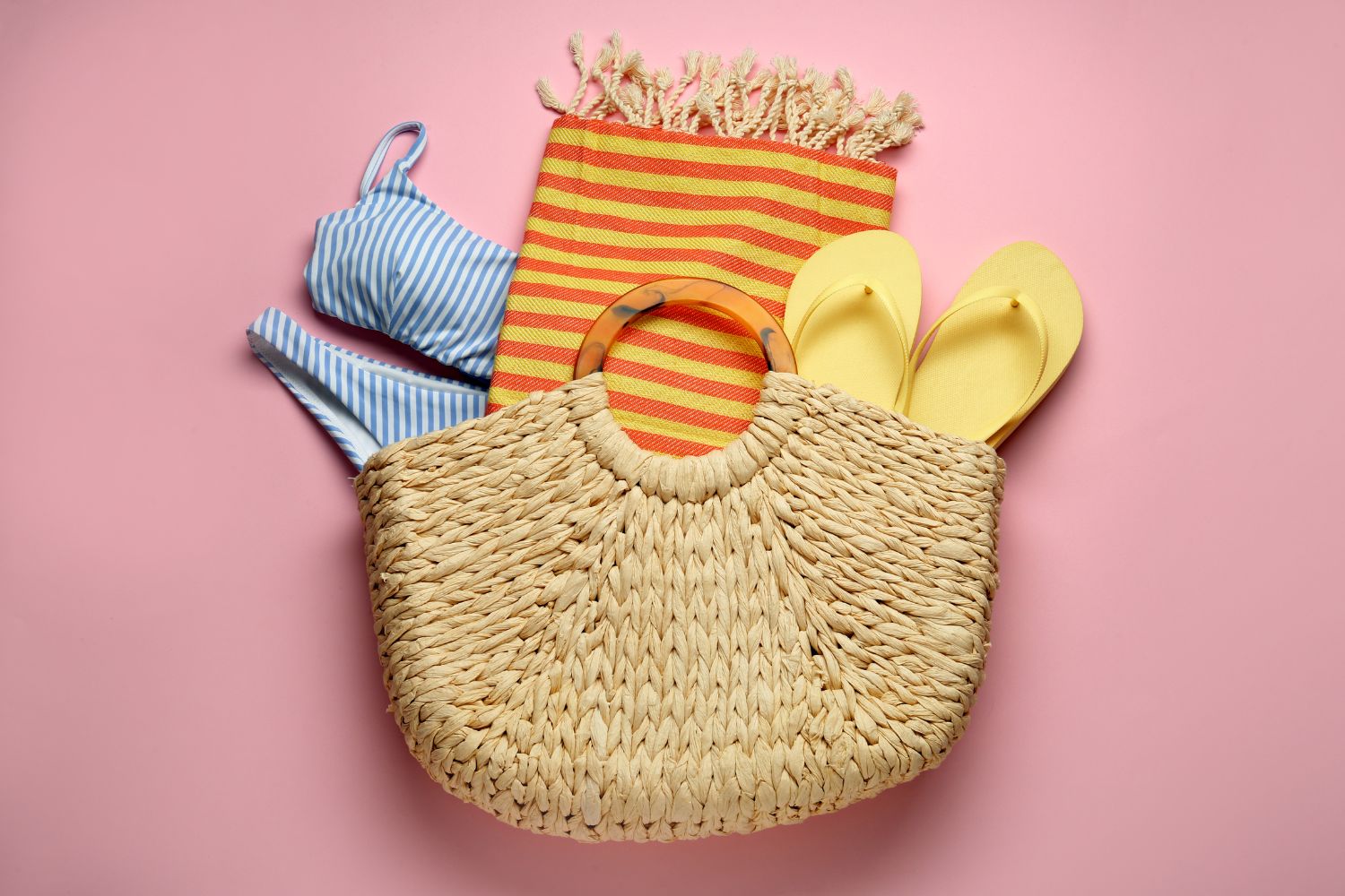 Beach bag with towel, swimsuit and flip flops