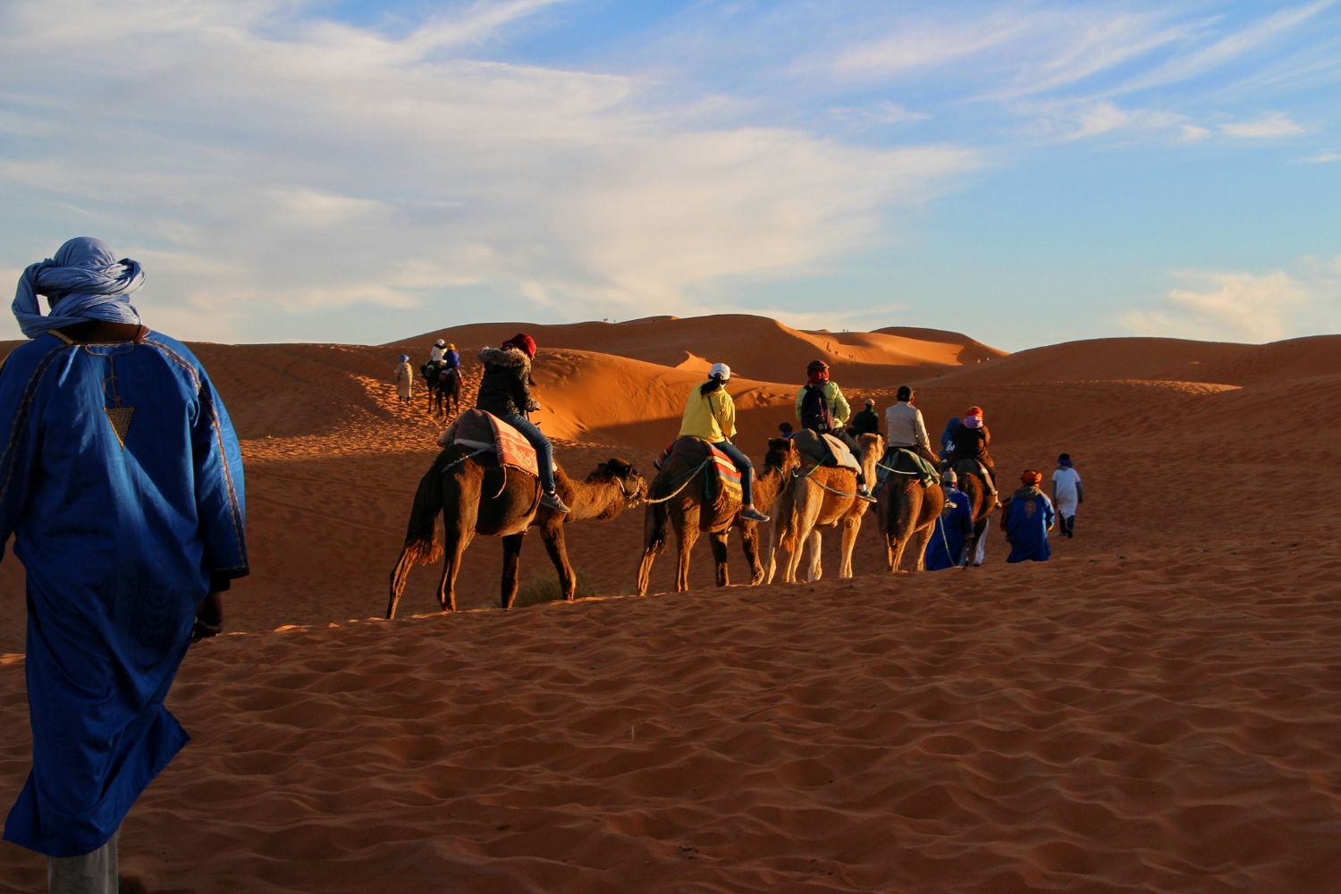 A group of tourists enjoying the Camel Adventure in the Sahara desert