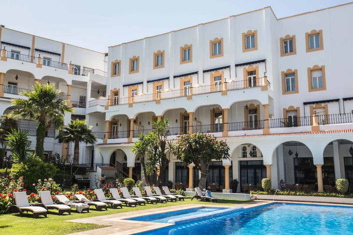 Outdoor pool and sun loungers at El Minzah Hotel 