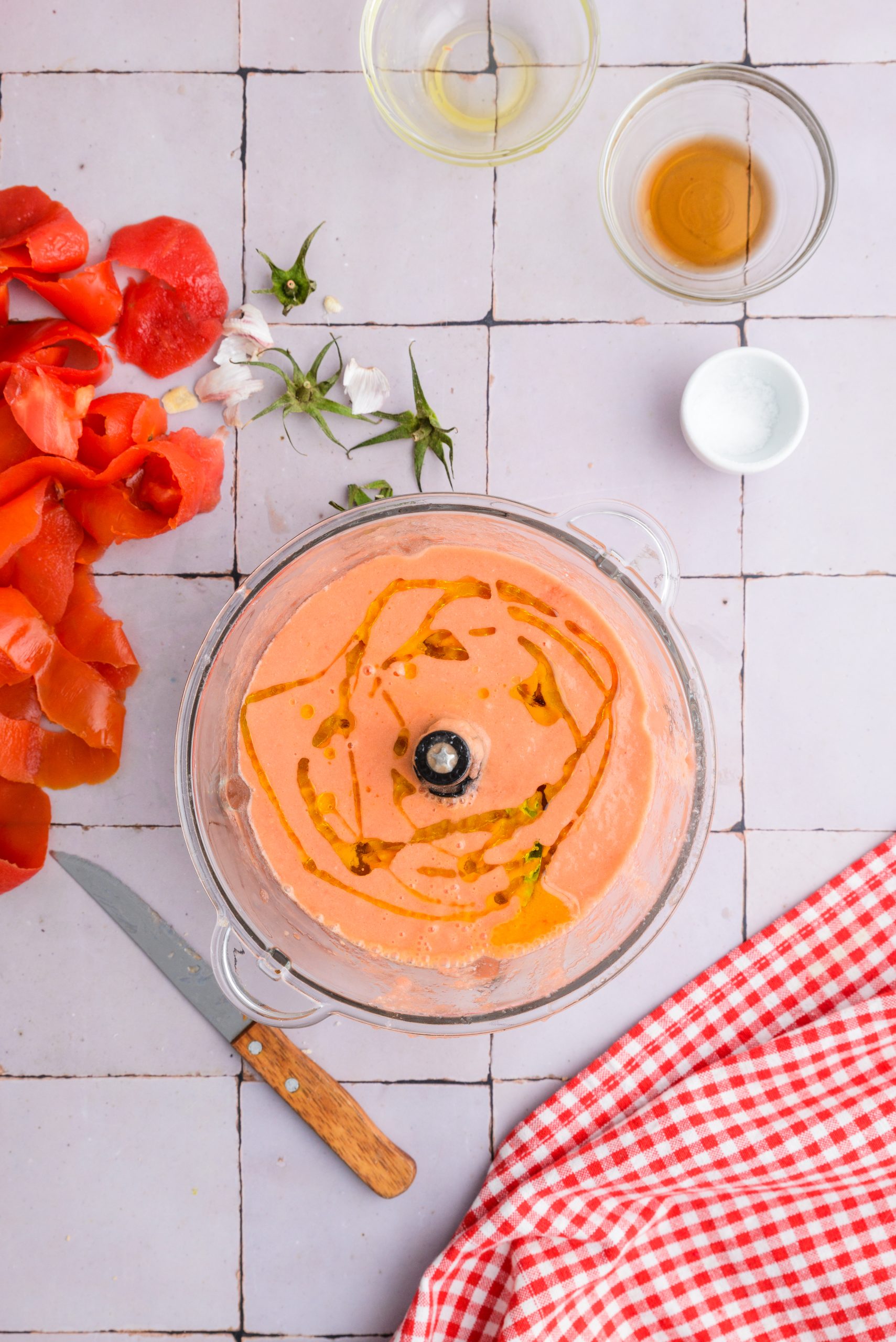 Salmorejo recipe: Slowly pour the olive oil into the running blender to emulsify the oil.