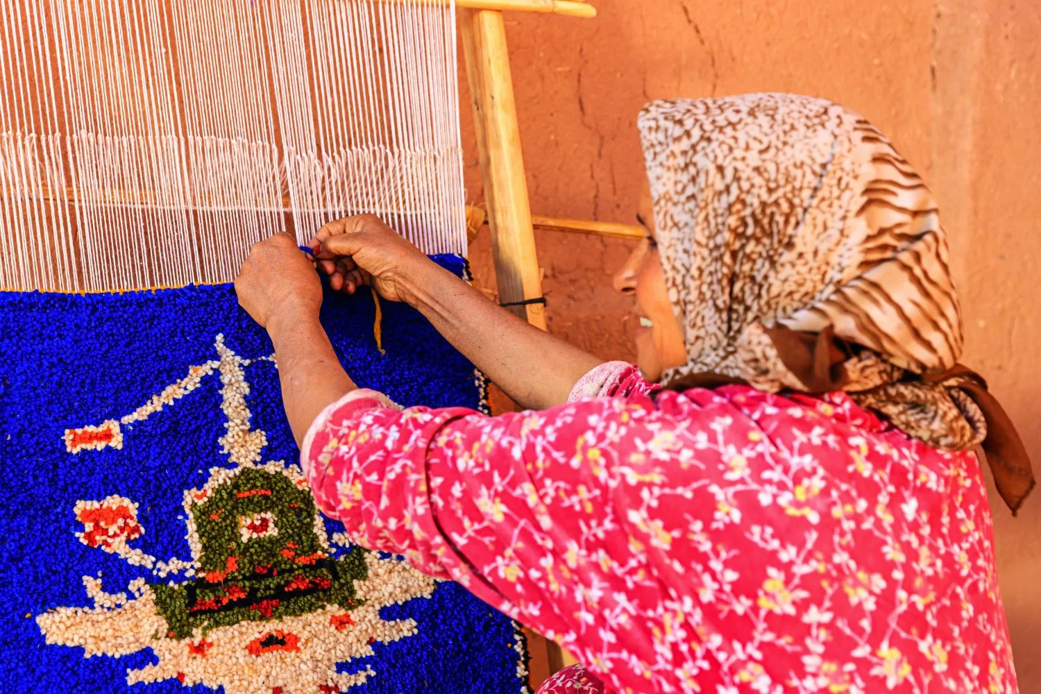 Berber woman weaving textiles in Morocco