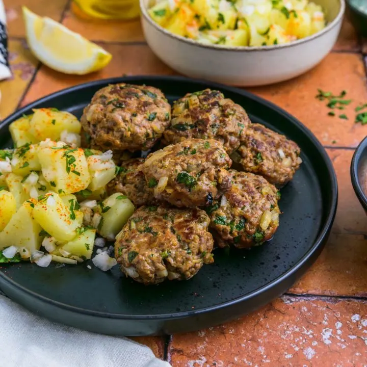 Moroccan kefta and potatoes served on a plate