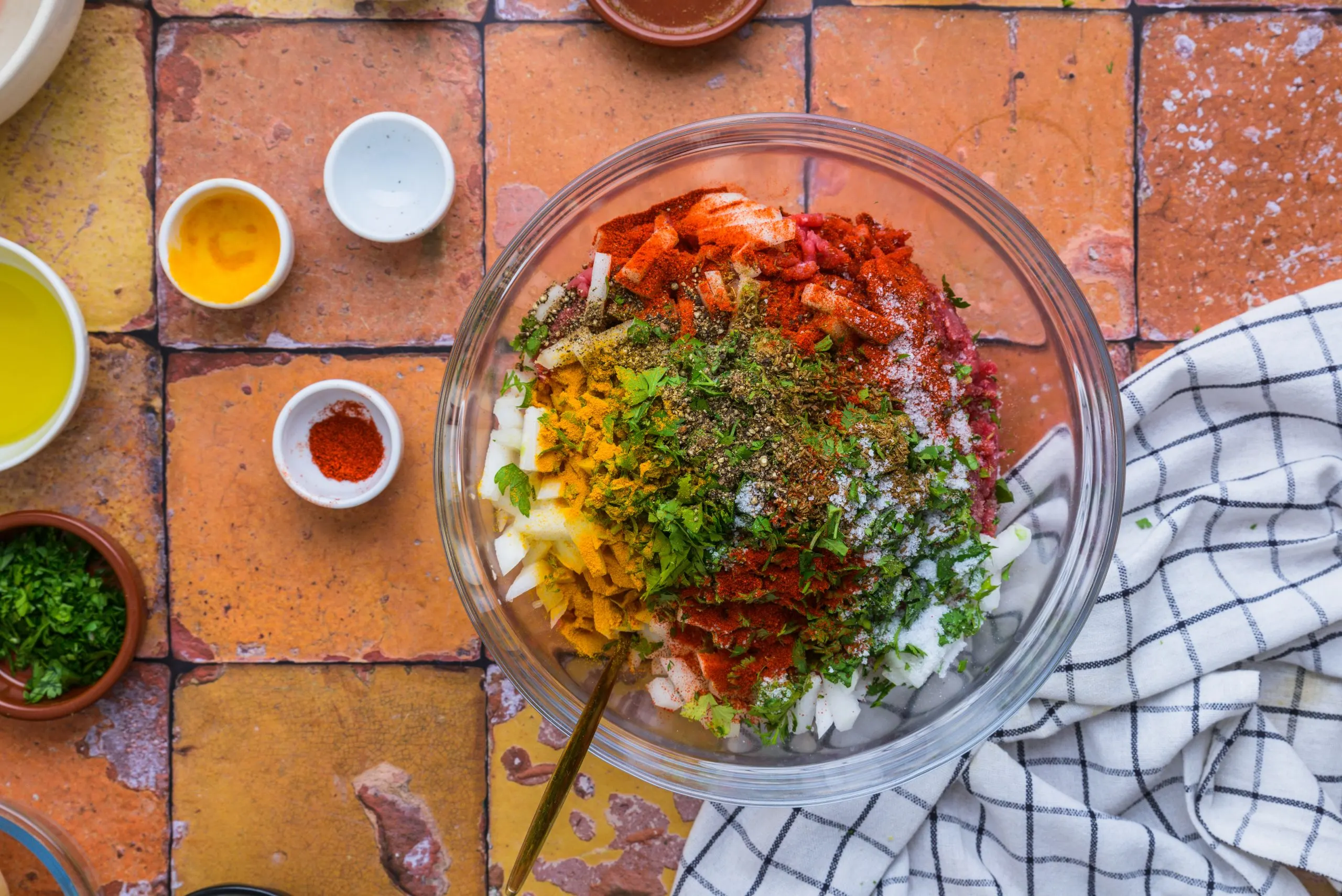 Mixing the ingredients in making Moroccan kafta and potatoes in a bowl