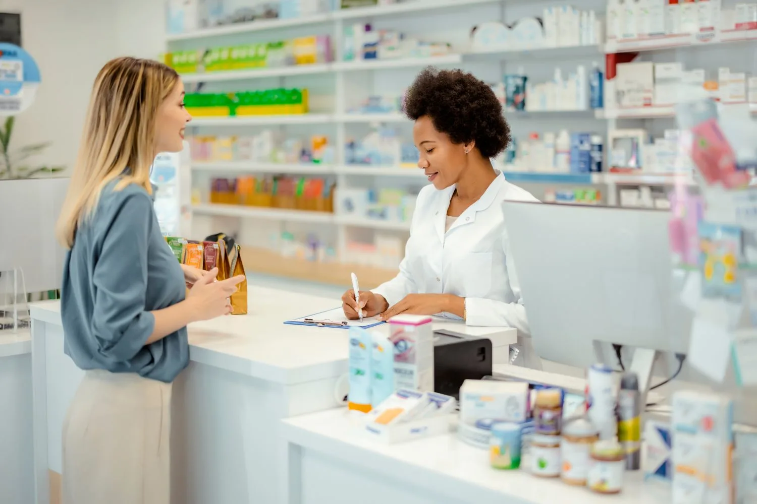 Female cashier in a pharmacy/drugstore advising a customer