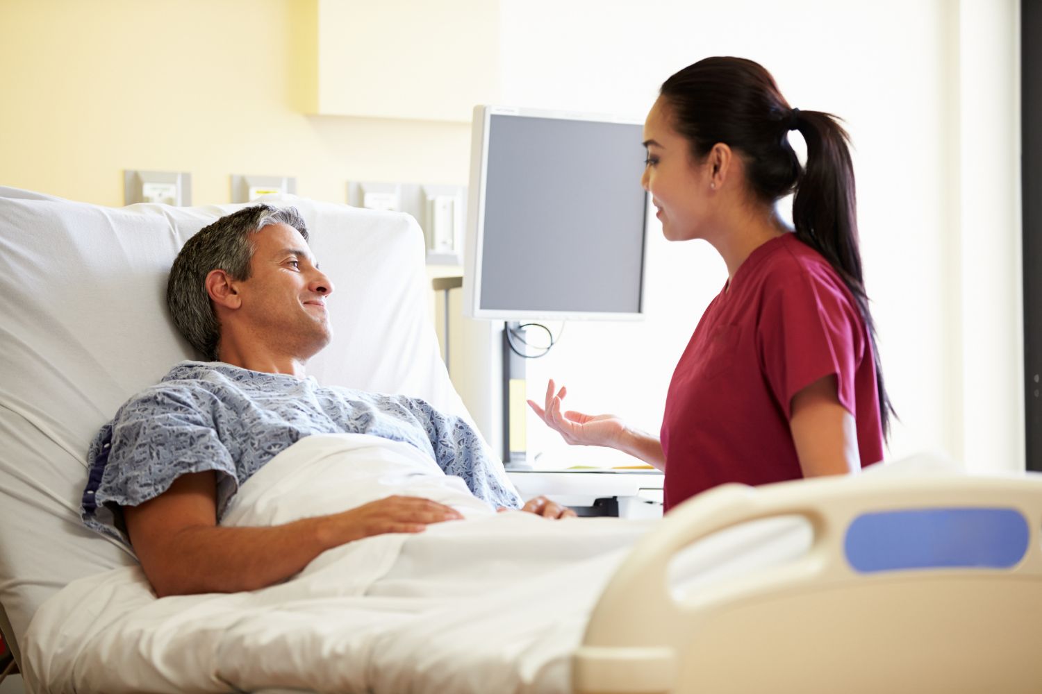 Female nurse talking to a patient in a hospital