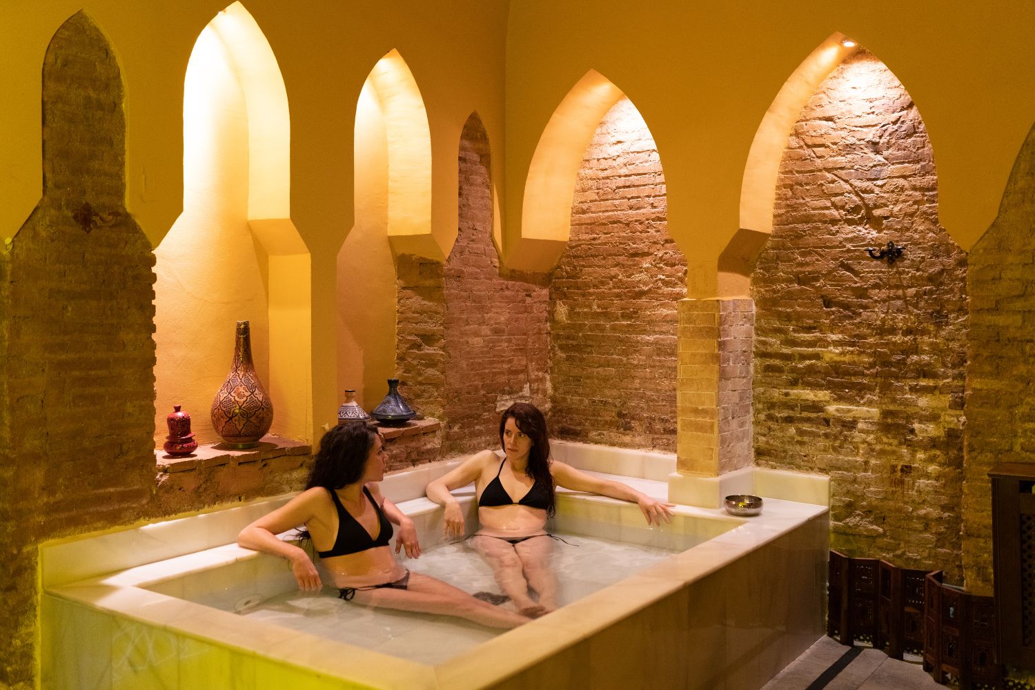 Two women enjoying in a Moroccan hammam 