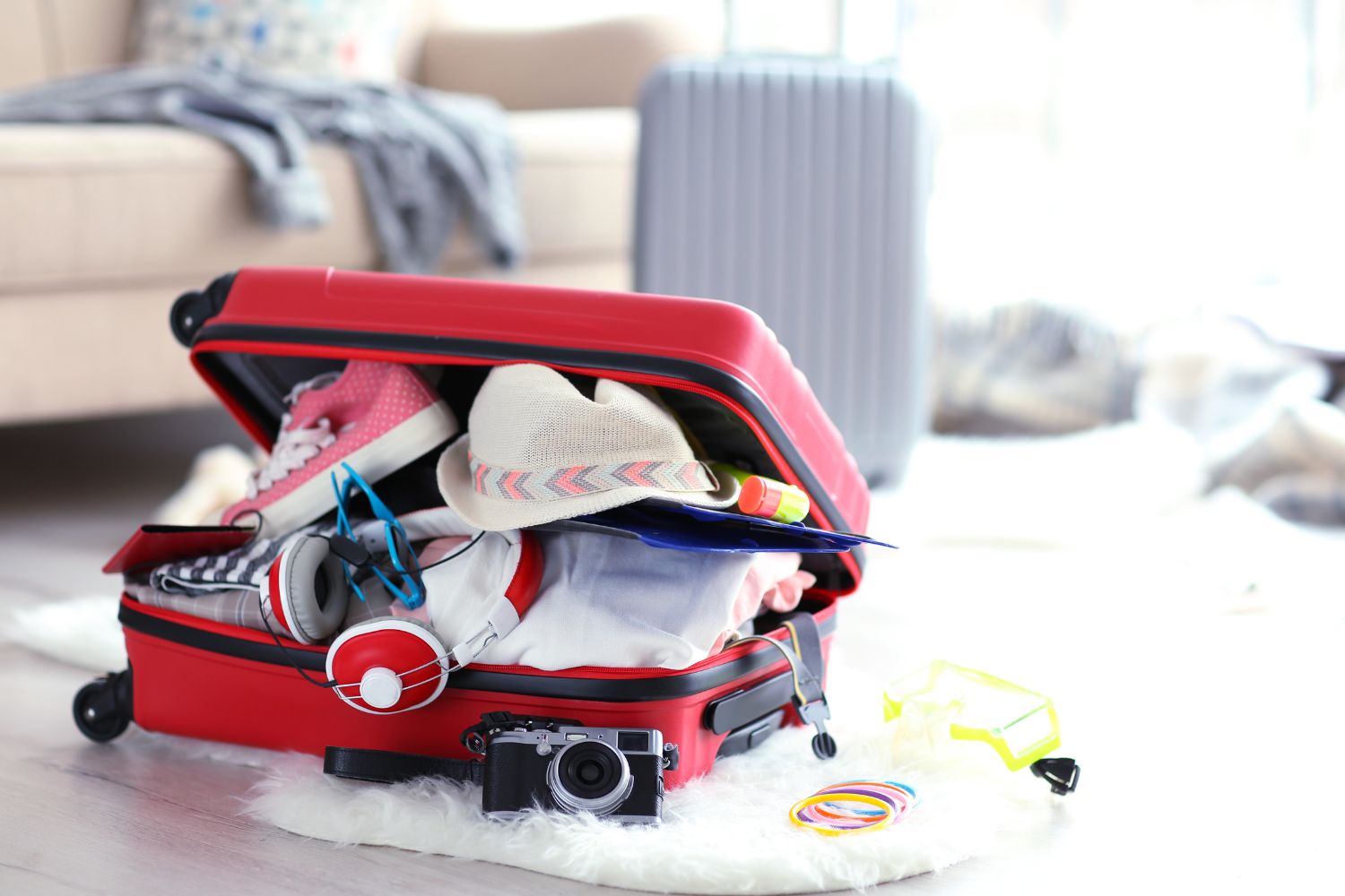 Overpacked red luggage in the living room