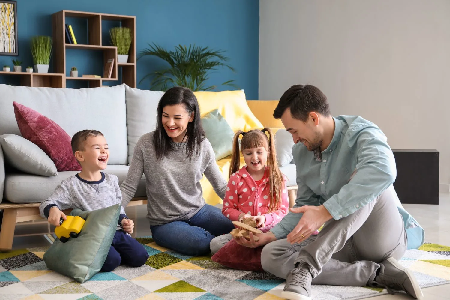 Parents playing with their children at home